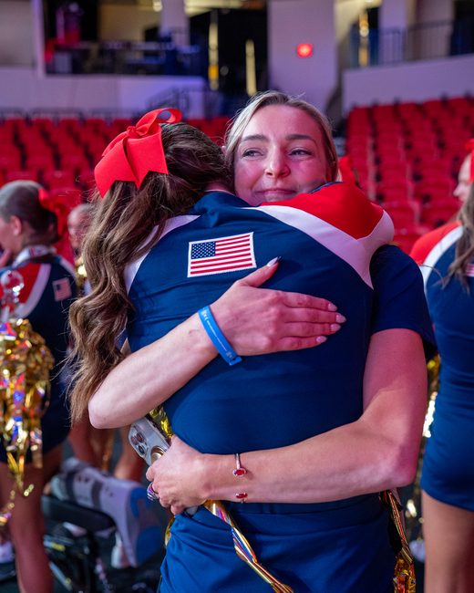 Mel Bull hugging an athlete after the win