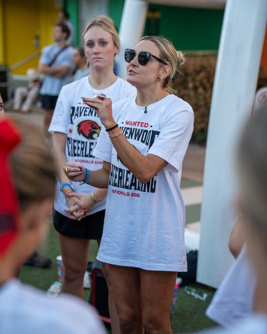Mel Bull talking to her athletes on the mat