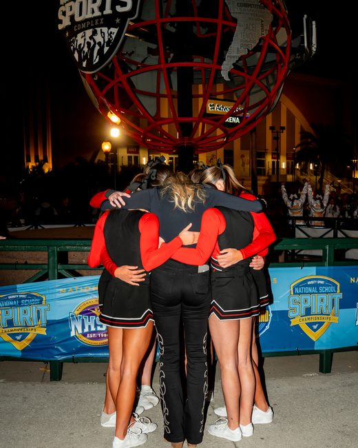 The team in a huddle before competing